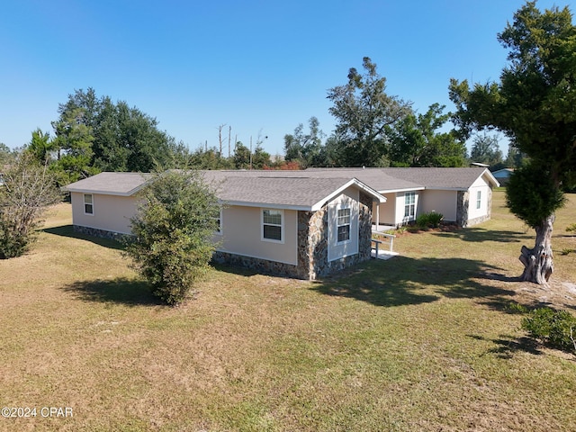 ranch-style home with a front lawn