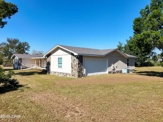 view of property exterior featuring stone siding, an attached garage, and a yard