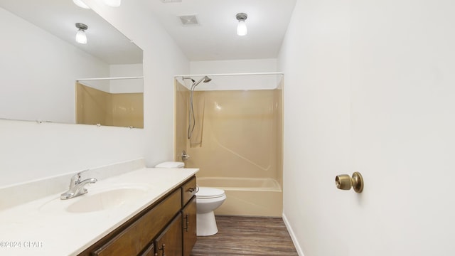 bathroom featuring visible vents, toilet, shower / tub combination, wood finished floors, and vanity