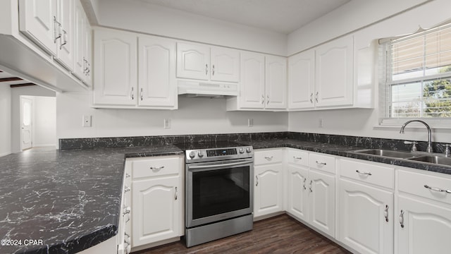 kitchen with dark stone countertops, a sink, white cabinets, electric stove, and under cabinet range hood