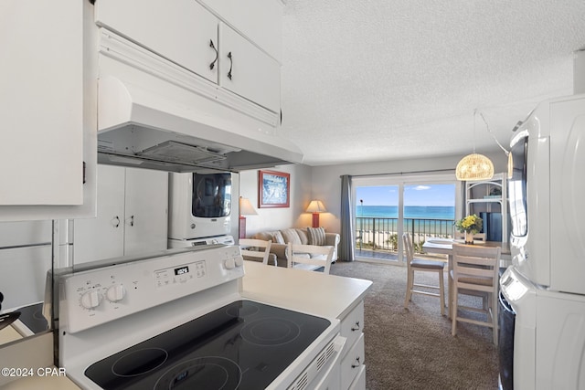 kitchen featuring stacked washer and dryer, a water view, white cabinets, light countertops, and white range with electric cooktop