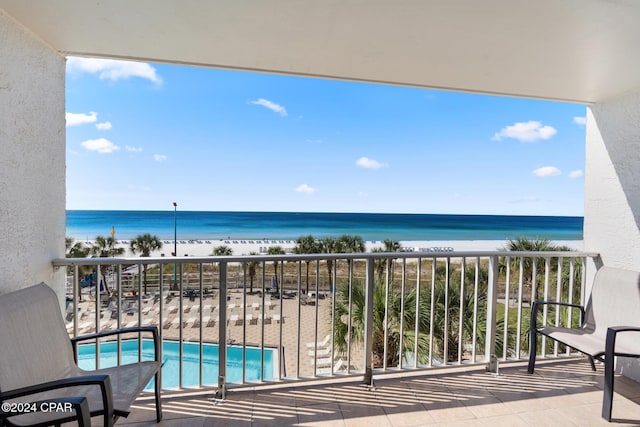 balcony with a water view and a beach view