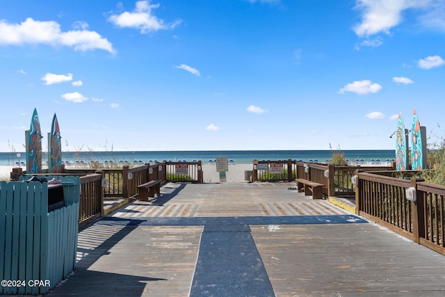 wooden terrace featuring a water view