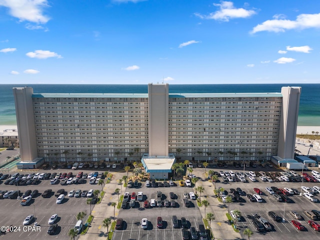 drone / aerial view featuring a water view and a beach view