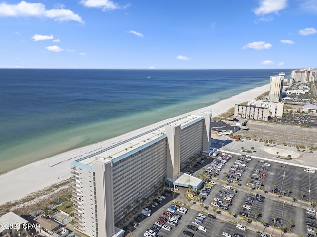 bird's eye view featuring a water view, a beach view, and a city view