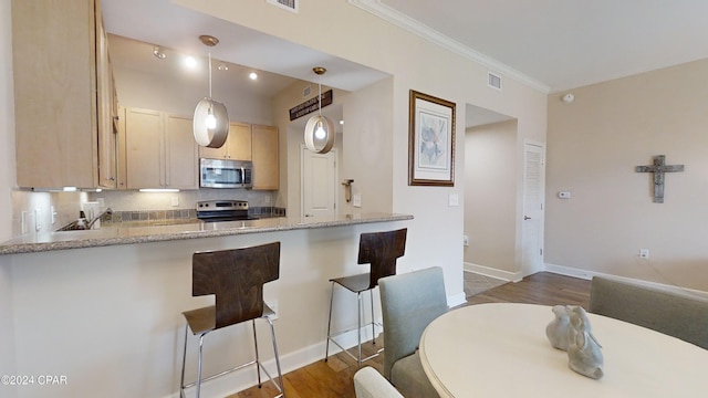 8700 Front Beach Rd Unit 5309, Panama City Beach, FL 32407 - kitchen featuring light brown cabinets, visible vents, ornamental molding, appliances with stainless steel finishes, and dark wood finished floors