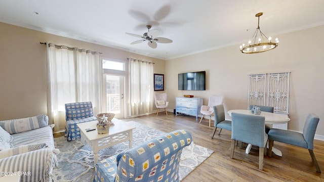 8700 Front Beach Rd Unit 5309, Panama City Beach, FL 32407 - living room featuring baseboards, ornamental molding, ceiling fan with notable chandelier, and wood finished floors