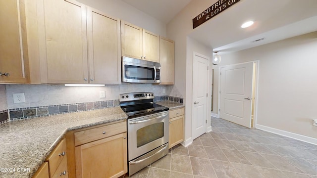 8700 Front Beach Rd Unit 5309, Panama City Beach, FL 32407 - kitchen featuring appliances with stainless steel finishes, light tile patterned floors, decorative backsplash, and light brown cabinetry