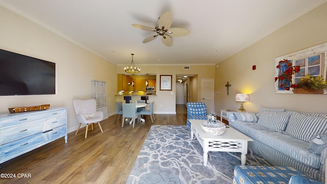 8700 Front Beach Rd Unit 5309, Panama City Beach, FL 32407 - living room with crown molding, visible vents, baseboards, wood finished floors, and ceiling fan with notable chandelier