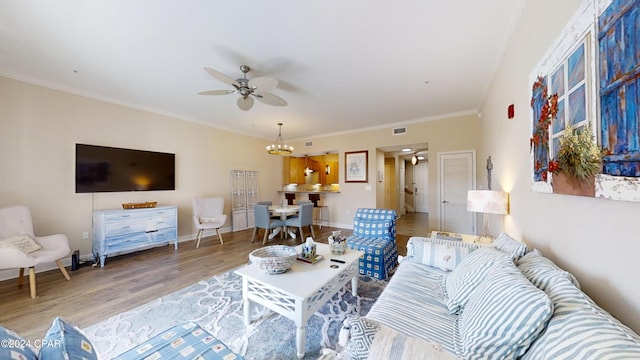 8700 Front Beach Rd Unit 5309, Panama City Beach, FL 32407 - living room with wood finished floors, ceiling fan with notable chandelier, baseboards, visible vents, and crown molding
