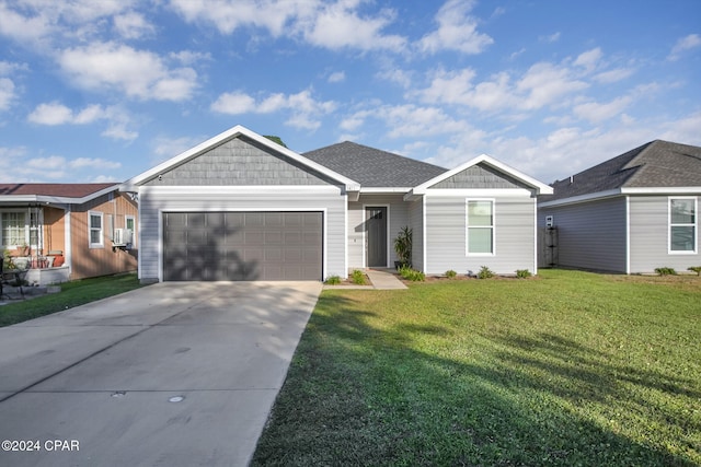 single story home featuring a front lawn and a garage