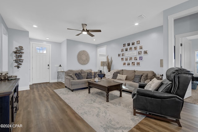 living room with ceiling fan and dark hardwood / wood-style flooring