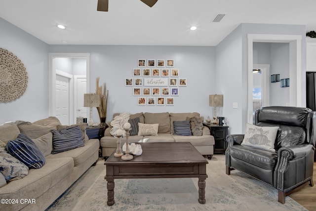 living room with light hardwood / wood-style floors and ceiling fan