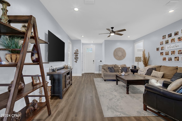 living room with wood-type flooring and ceiling fan