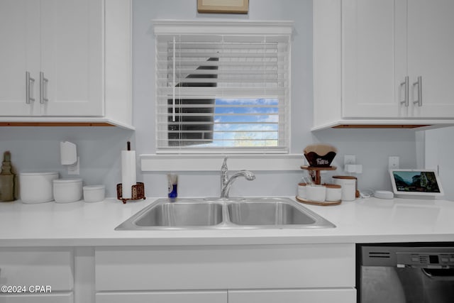 kitchen with sink, dishwasher, and white cabinets