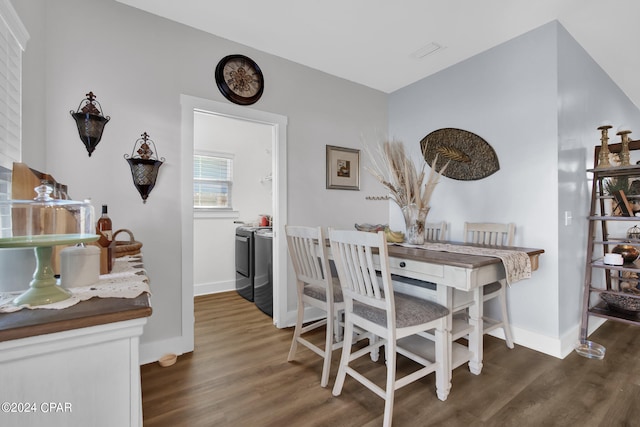 dining space with dark wood-type flooring and washer and dryer