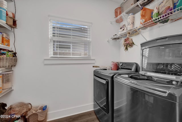 laundry room with washer and clothes dryer and dark hardwood / wood-style floors