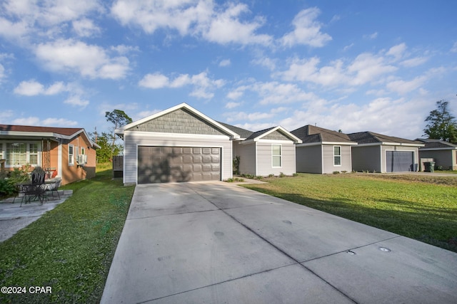 ranch-style home with a front yard, a garage, and cooling unit