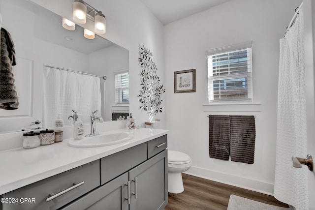 bathroom featuring vanity, a shower with shower curtain, hardwood / wood-style flooring, and toilet