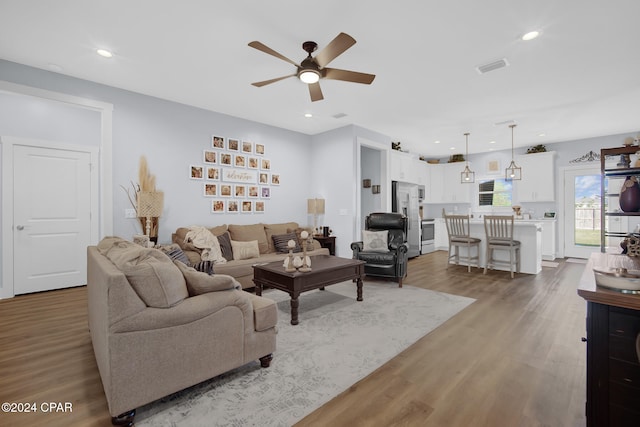 living room featuring hardwood / wood-style flooring and ceiling fan