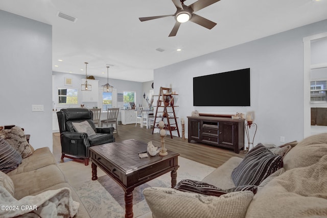 living room featuring light hardwood / wood-style floors and ceiling fan