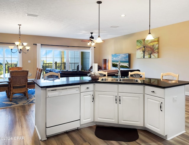 kitchen featuring dishwasher, a wealth of natural light, and white cabinets