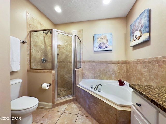 full bathroom with tile patterned floors, toilet, vanity, shower with separate bathtub, and a textured ceiling