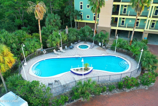 view of pool featuring a patio and a hot tub