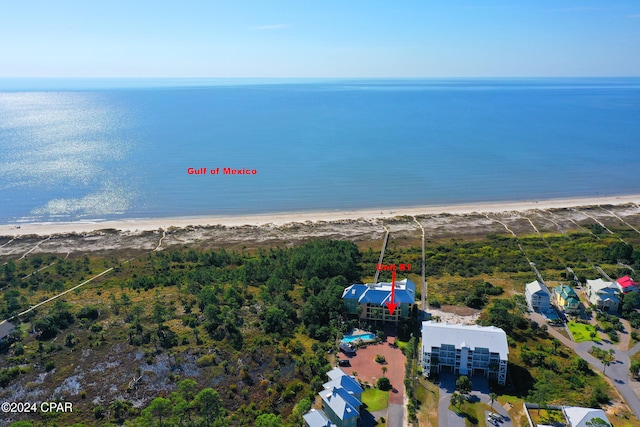 drone / aerial view featuring a water view and a beach view