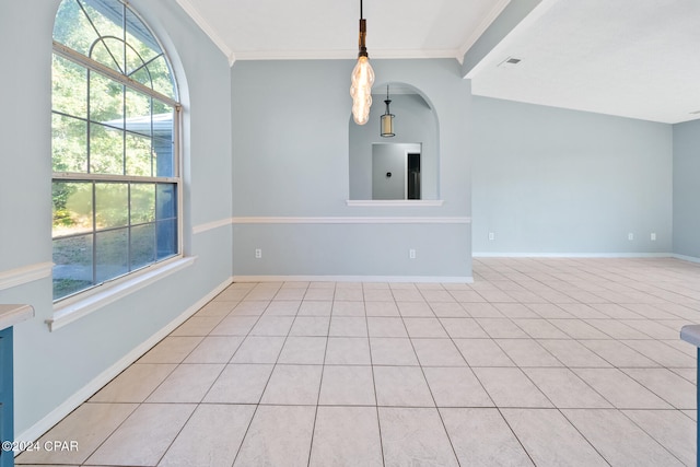 empty room featuring lofted ceiling, light tile patterned floors, and ornamental molding