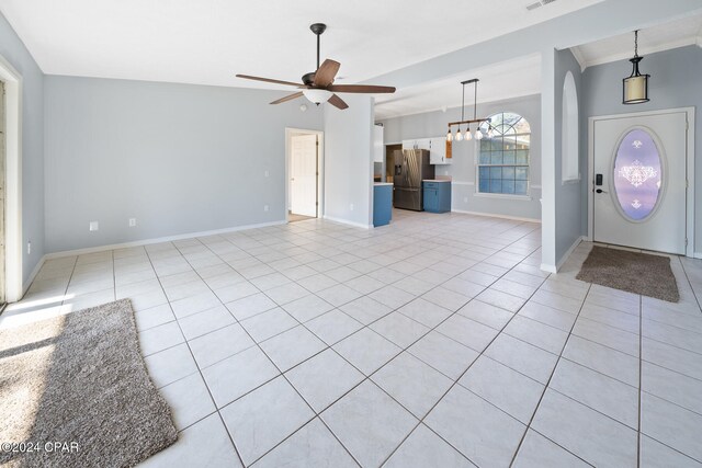 tiled entryway featuring ceiling fan