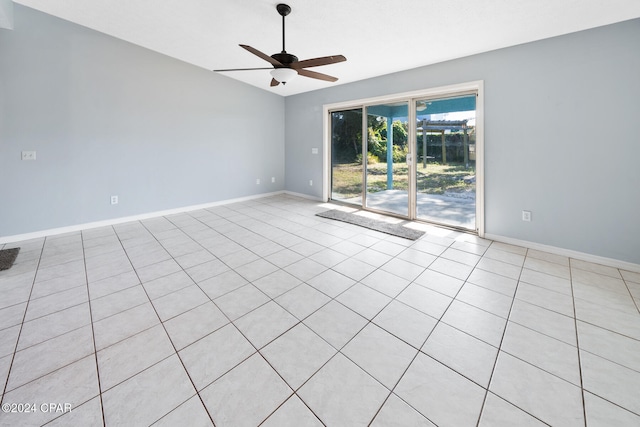 tiled spare room featuring ceiling fan