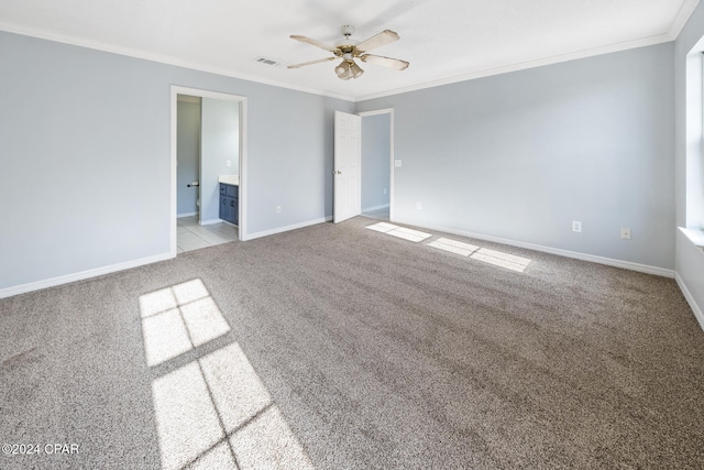 carpeted spare room with ceiling fan and crown molding