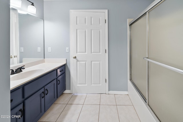 bathroom featuring bath / shower combo with glass door, vanity, and tile patterned flooring