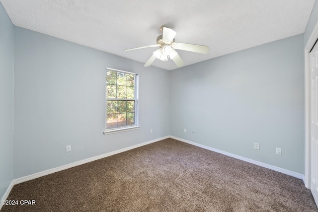 carpeted spare room with ceiling fan and a textured ceiling