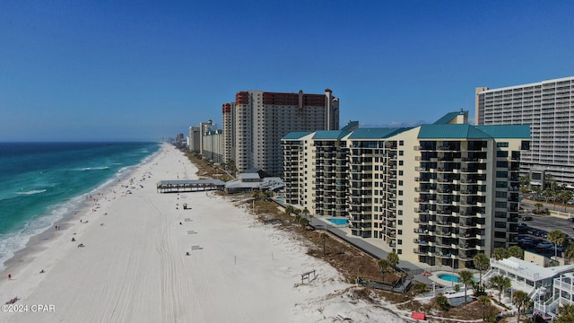 drone / aerial view featuring a water view and a beach view