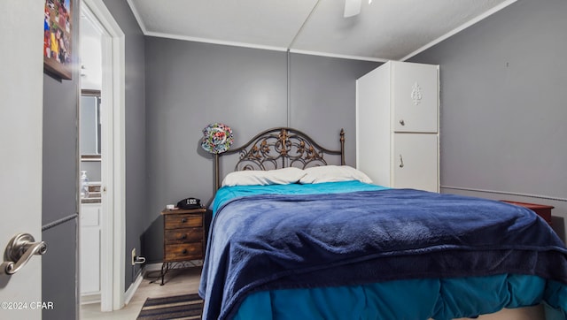 bedroom with crown molding, light wood-type flooring, and ceiling fan