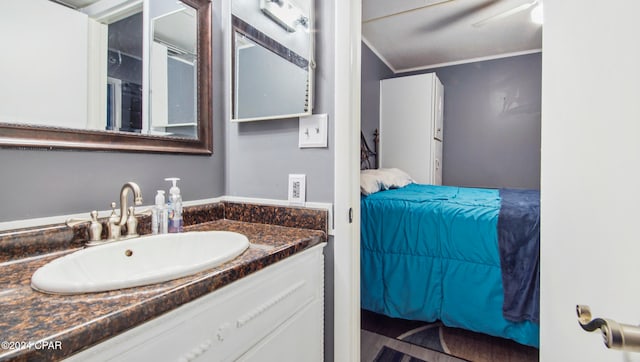 bathroom with vanity and ornamental molding