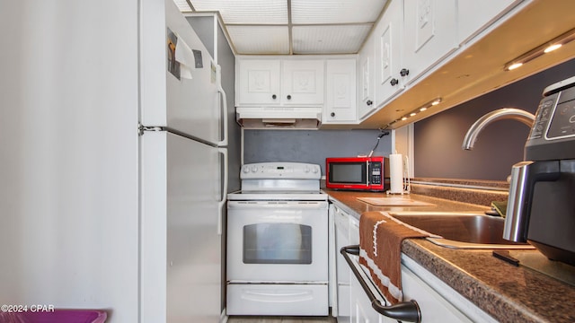 kitchen featuring white cabinets and white appliances