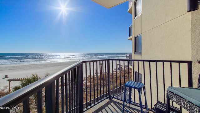 balcony with a view of the beach and a water view