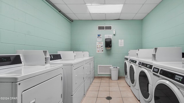 washroom with light tile patterned flooring and washing machine and clothes dryer