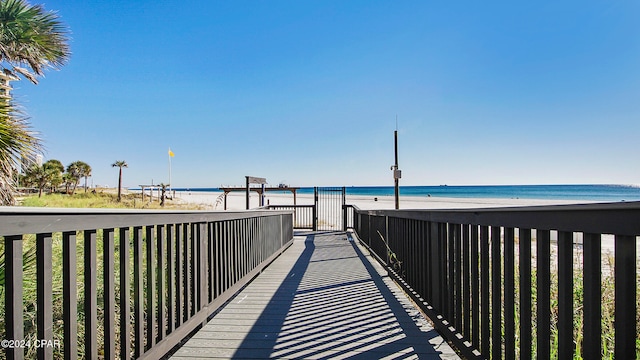 view of home's community featuring a water view and a beach view