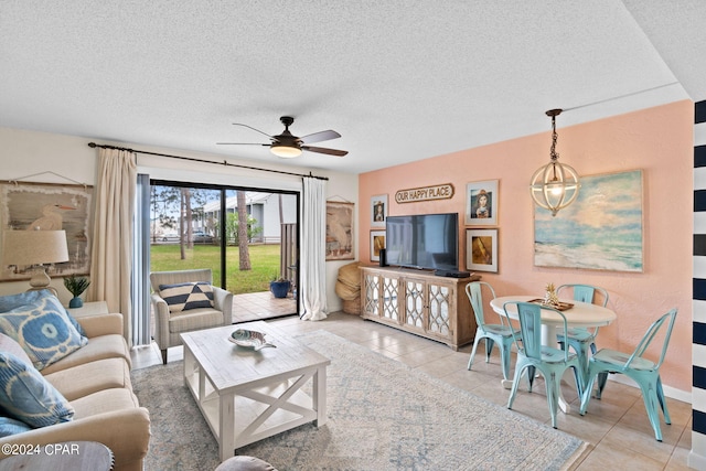 tiled living room with ceiling fan and a textured ceiling