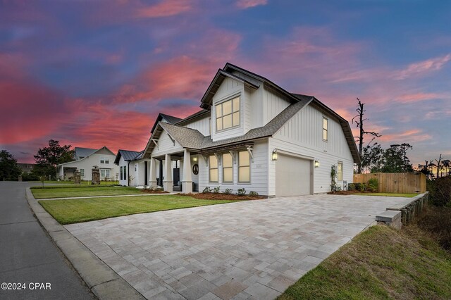 view of front facade with a garage and a lawn