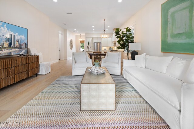 living room with ceiling fan and light wood-type flooring