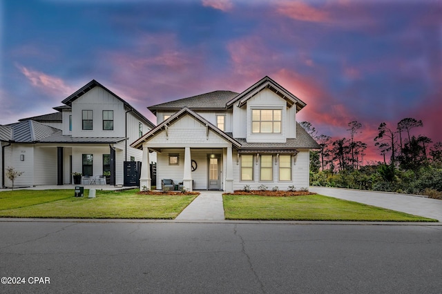 view of front of home featuring a porch and a yard