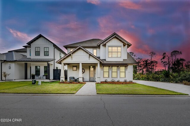 view of front of house featuring a porch and a yard