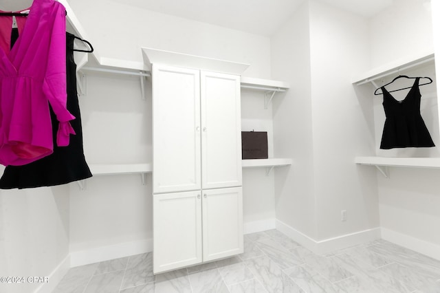 spacious closet with marble finish floor