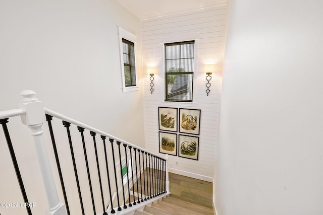 staircase with baseboards and wood finished floors