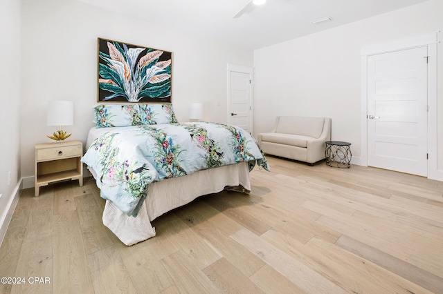 bedroom featuring light wood-style flooring and baseboards